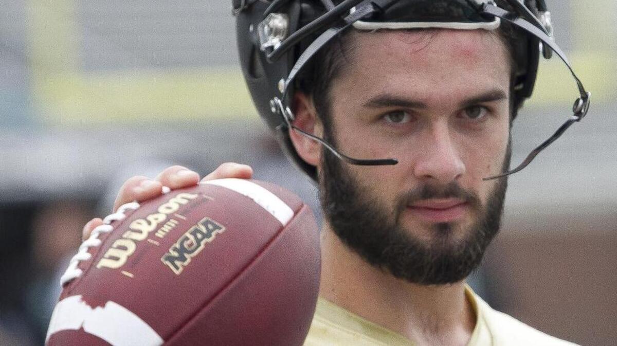Alex Ross warms up on the sidelines during the first day of Coastal Carolina Football practice at Brooks Stadium.
