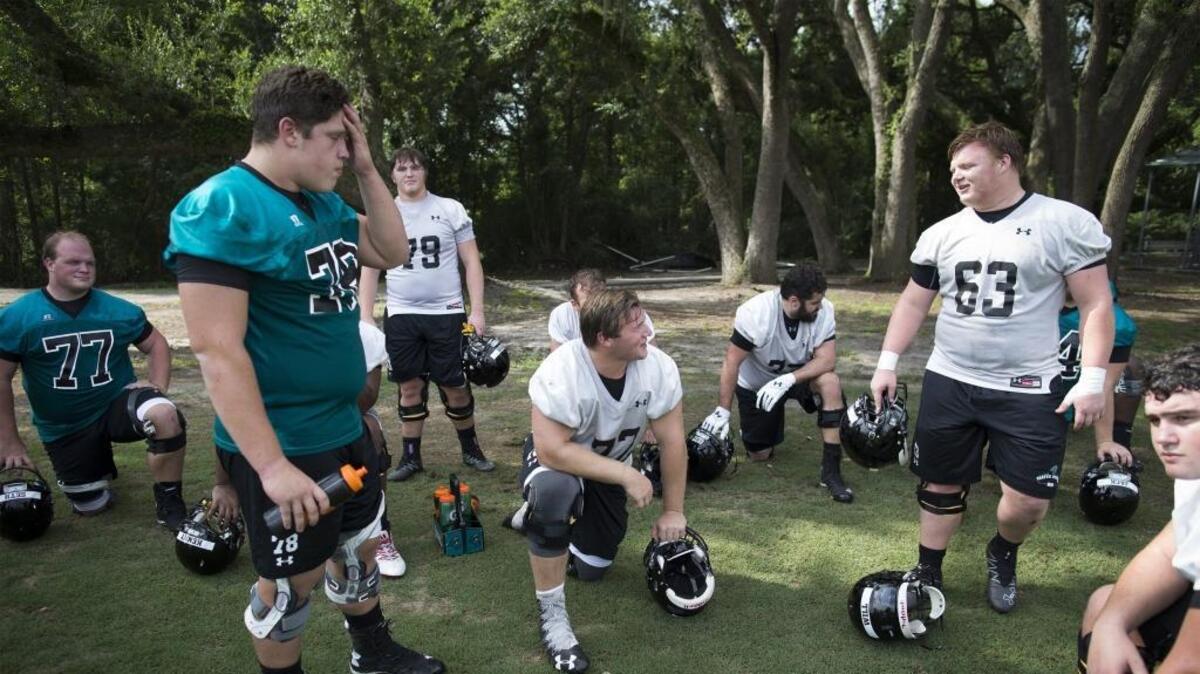 Members of Coastal Carolina’s offensive line take a break during a practice. The Chanticleers are starting the youngest and least experienced offensive line in FBS football.