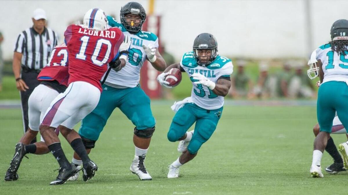 
Coastal Carolina running back De’Angelo Henderson (31) looks for running room against South Carolina State on Saturday.
