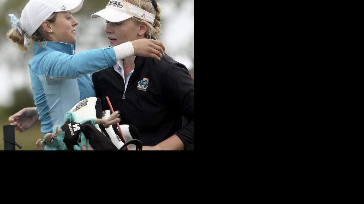 
Lena Schaeffner (left) and Coastal Carolina University team member Malene Krolbell-Hansen embrace as Schaeffner wins the 2015 Big South Women's Golf Championship at DeBordieu on Wednesday.
