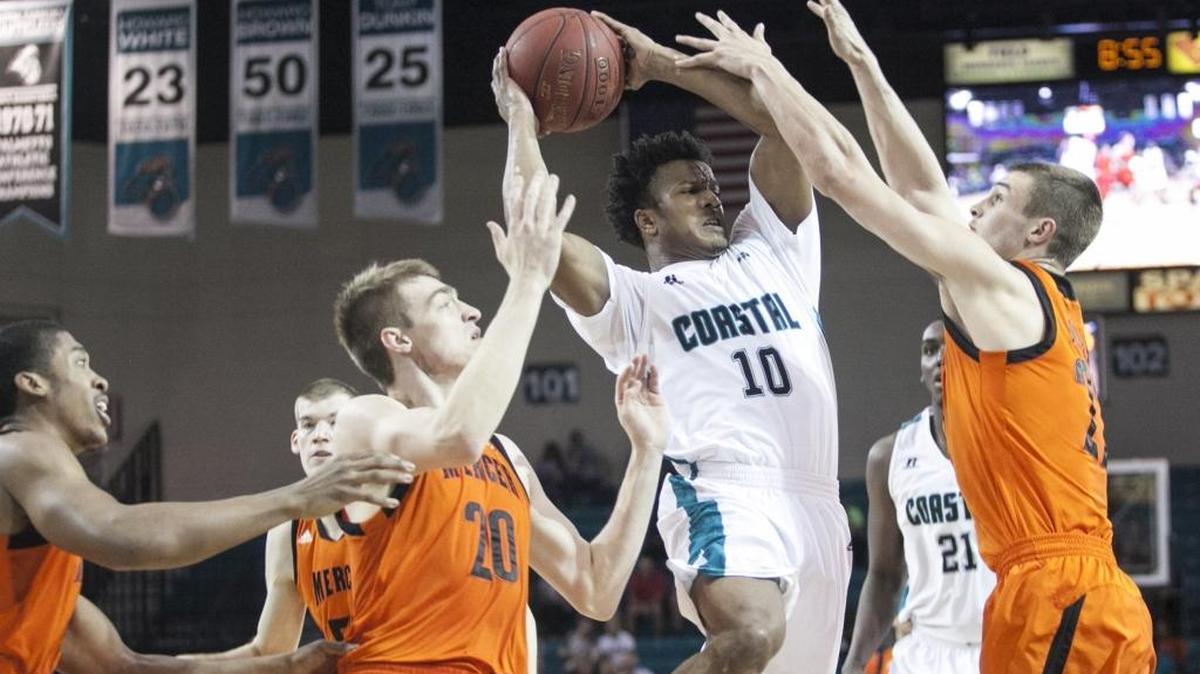 Coastal Carolina’s Shivaughn Wiggins is surrounded by Mercer defenders during Tuesday’s opening round game of the College Insider.com Tournament.