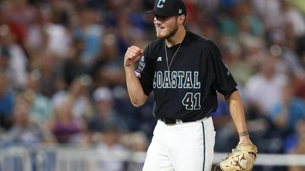 Coastal Carolina starting pitcher Andrew Beckwith (41) pumps his fist after striking out Florida's Buddy Reed (23) to close out the bottom of the eighth inning Monday.