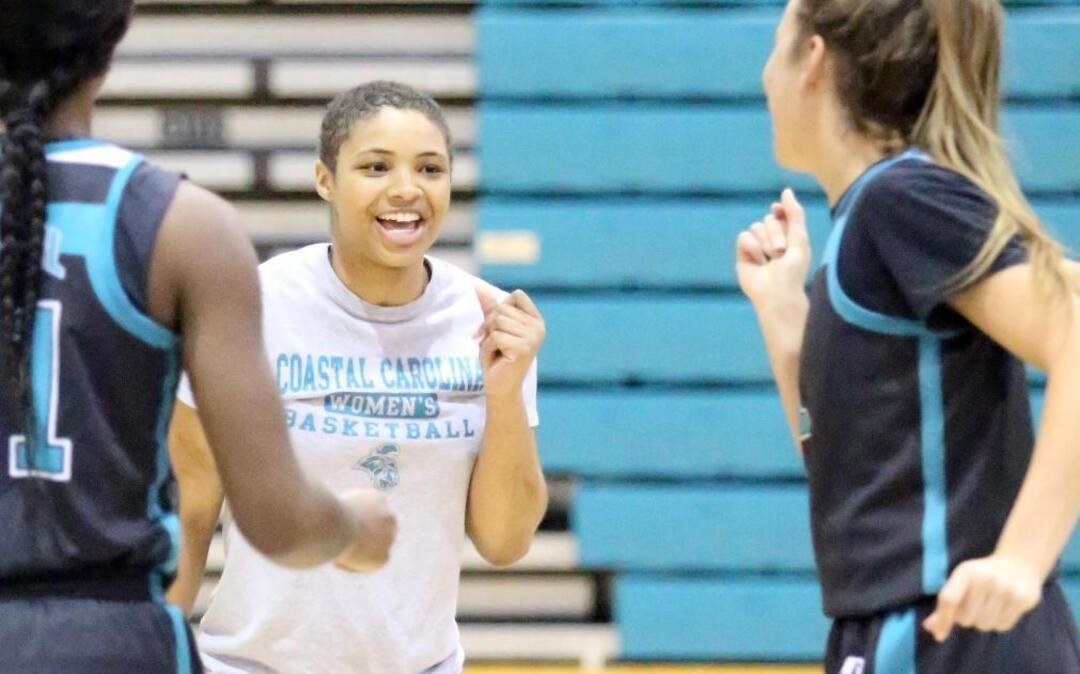 Coastal Carolina’s Di’janai Williams (center) dances with teammates during Tuesday’s practice. Williams missed her rookie season due to cancer treatments, but attends the practices and games.