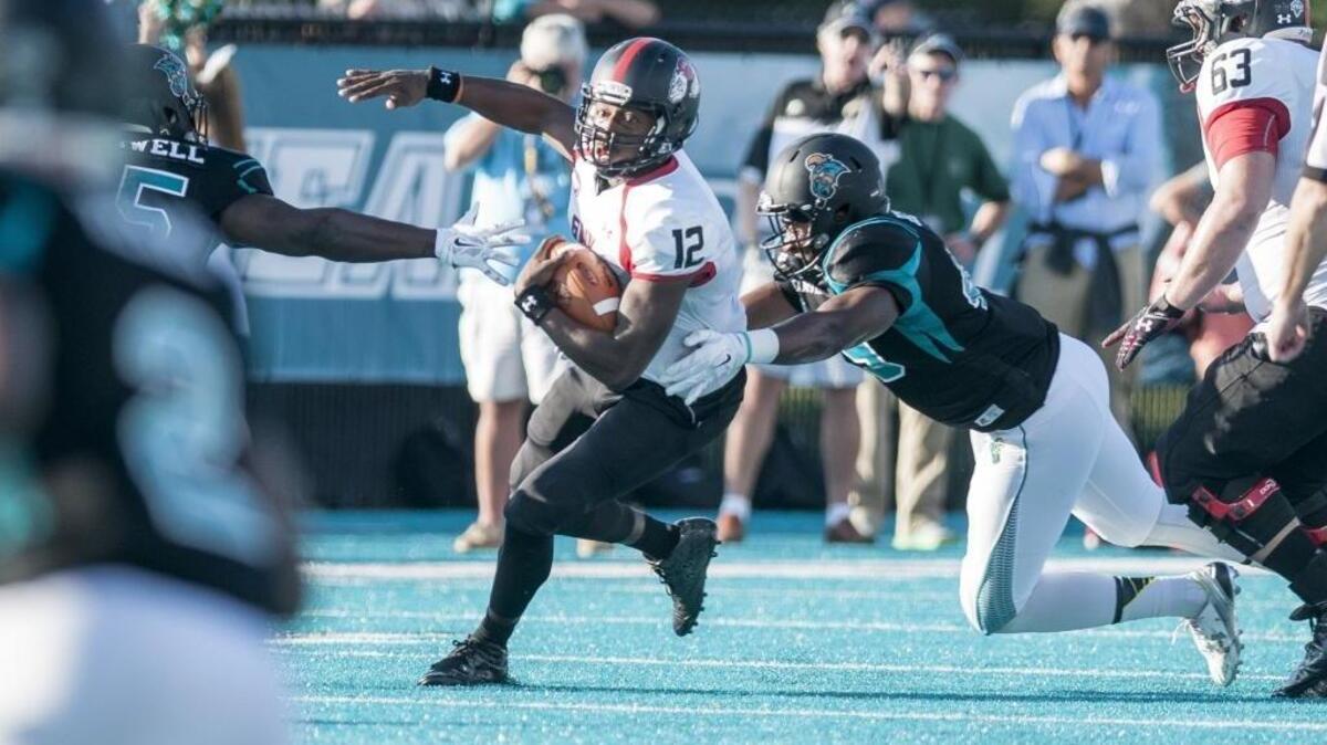 Gardner-Webb’s Tyrell Maxwell tries to escape the Coastal Carolina defense.