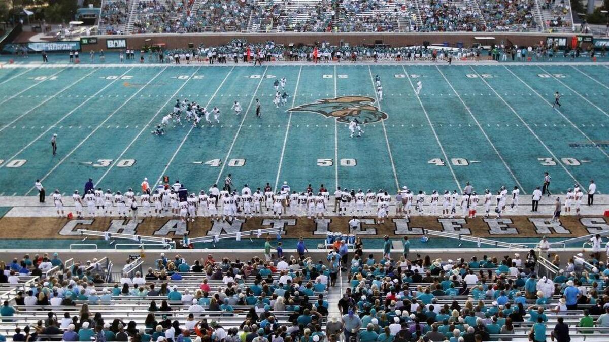 Left: Coastal Carolina takes on Western Illinois on its new teal turf at Brooks Stadium.