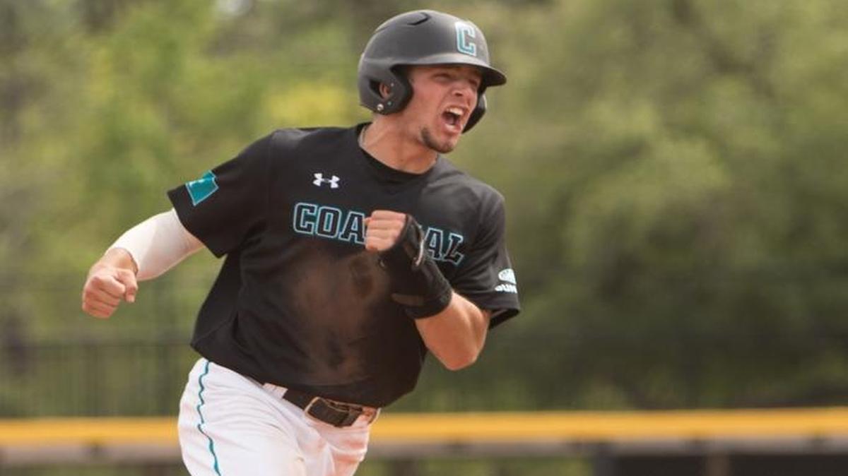 Coastal Carolina’s Cory Wood cheers between second and third base after a long fly ball by Kevin Woodall Jr.