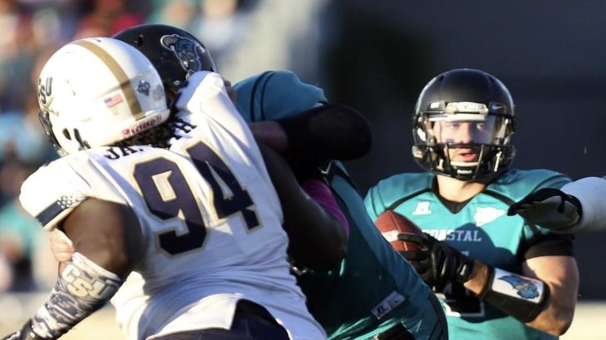 FILE PHOTO: Coastal Carolina’s Alex Ross (center) looks to throw during last year’s 43-22 win over Charleston Southern at Brooks Stadium in Conway.