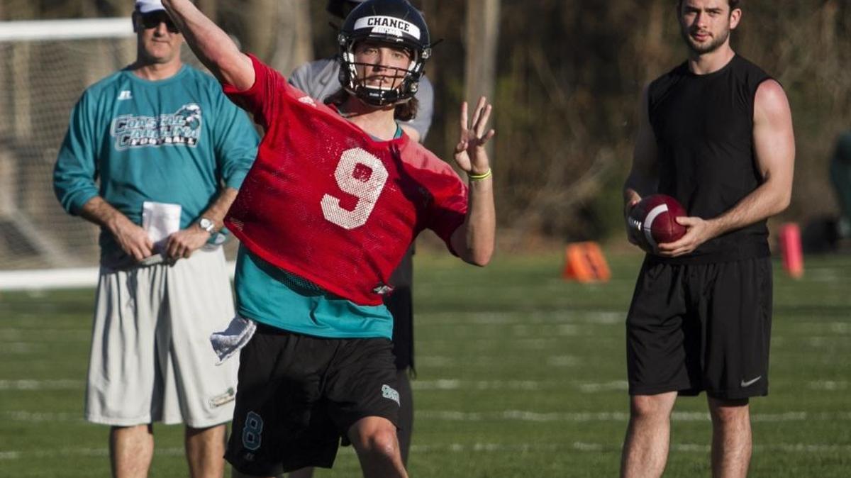 Coastal Carolina’s Chance Thrasher makes a throw while former Chanticleers quarterback Alex Ross (right) watches during the first spring practice Tuesday.