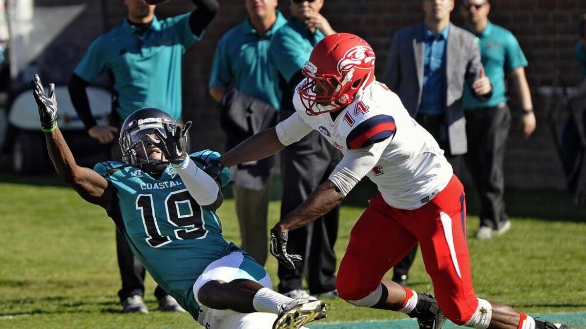 
Coastal Carolina wide receiver John Israel slips down as he reaches for this Alex Ross pass during their game with Liberty.
