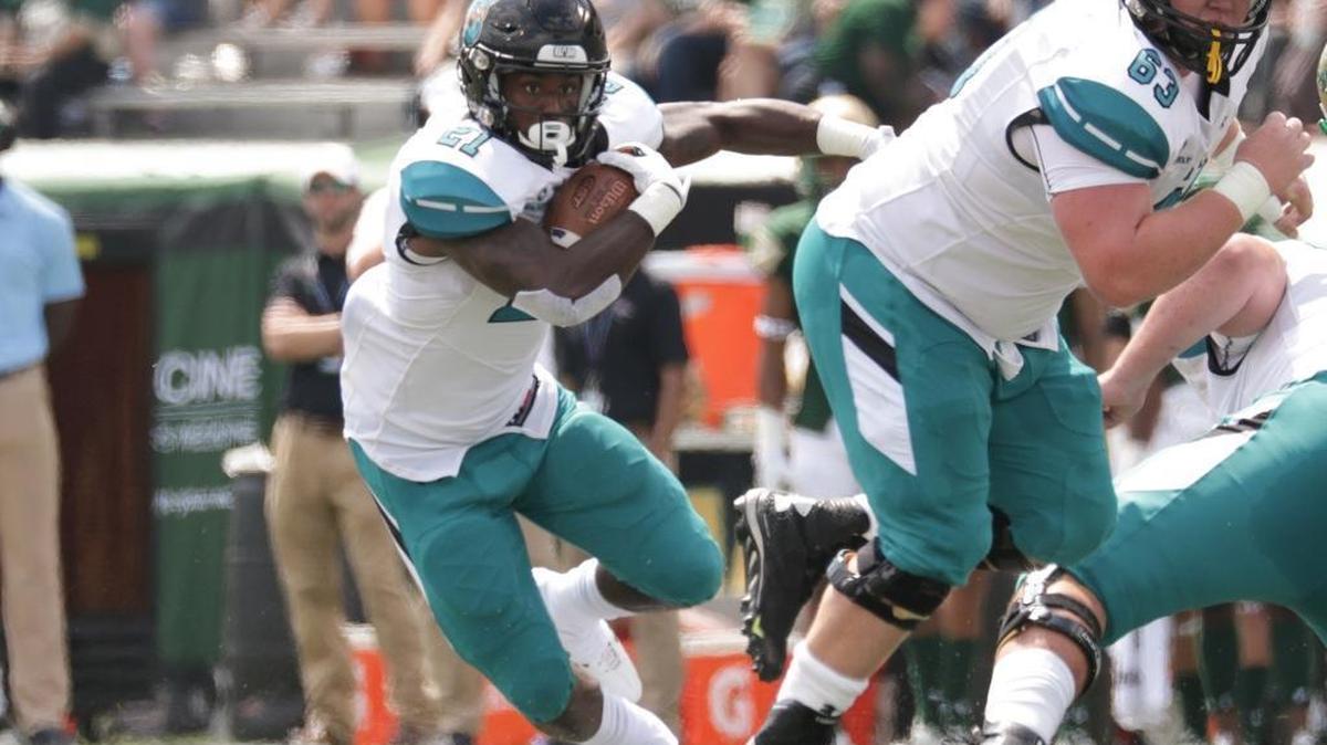 Coastal Carolina senior running back Marcus Outlow (21), pictured against Alabama-Birmingham earlier this season, gained 71 yards and scored a touchdown on 19 carries Saturday in Coastal’s 45-21 loss at Troy.