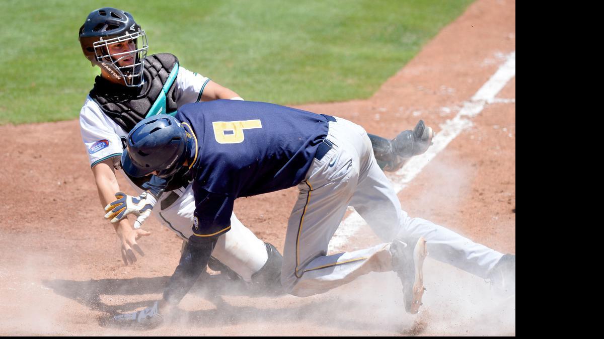 
California’s Preston Grand Pre (9) is safe at home after a collison with Coastal Carolina catcher Matt Beaird during the top of the sixth inning.
