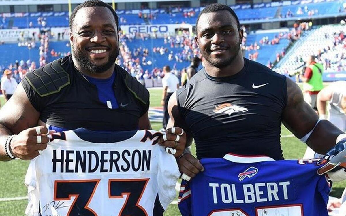 Coastal Carolina graduates Mike Tolbert (left) of the Buffalo Bills and De’Angelo Henderson of the Denver Broncos exhanged signed jerseys following the Bills’ 26-16 win over Denver on Sunday in Buffalo.