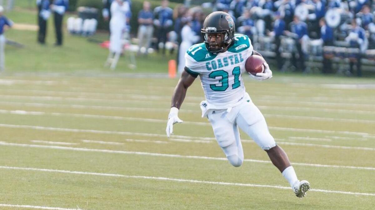 
Coastal Carolina’s De’Angelo Henderson runs the ball against Furman last Saturday.
