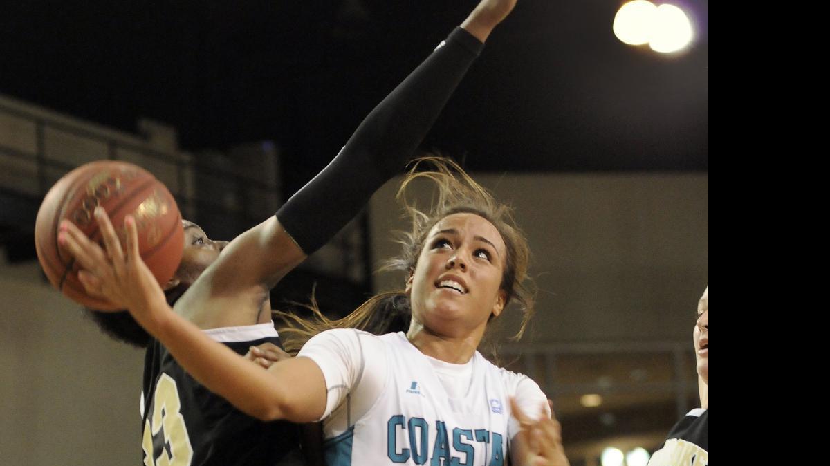 
Coastal Carolina guard, Stephanie Isaacs (right) takes a shot around UNC Pembroke forward Katelyn Haney during the first half of a game at the HTC Center. The NCAA voted in January to permit all Division I schools to provide additional money to student-athletes to cover the full “cost of attendance.” Coastal Carolina and the Big South will adopt the new COA benefits for men’s and women’s basketball players next school year.

