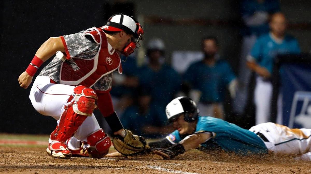 Coastal Carolina’s Billy Cooke (right) is caught stealing home as N.C. State’s Andrew Knizner (11) makes the tag in the fourth inning of the second game Monday.