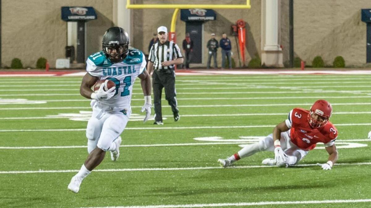 Coastal Carolina running back DeAngelo Henderson sprints toward the end zone on his way to a 71-yard touchdown run. It was not enough though, as the Chants fell to Liberty, 24-21.