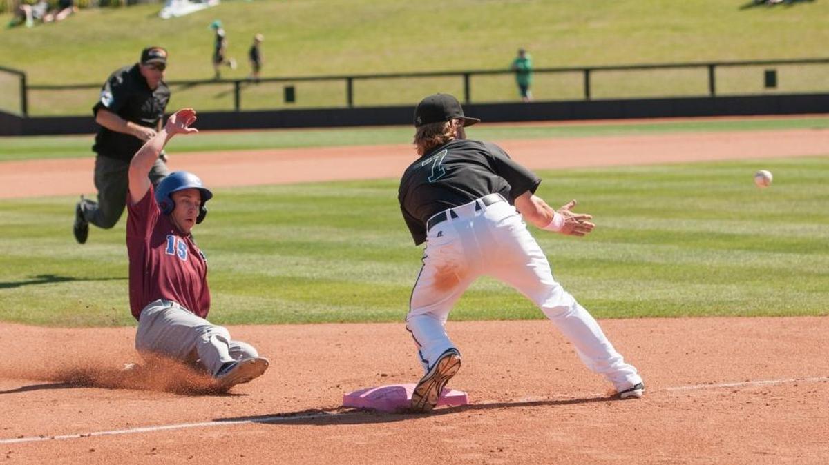 Presbyterian’s Weston Jackson slides into third as Coastal Carolina’s Zach Remillard reaches for the throw Sunday.
