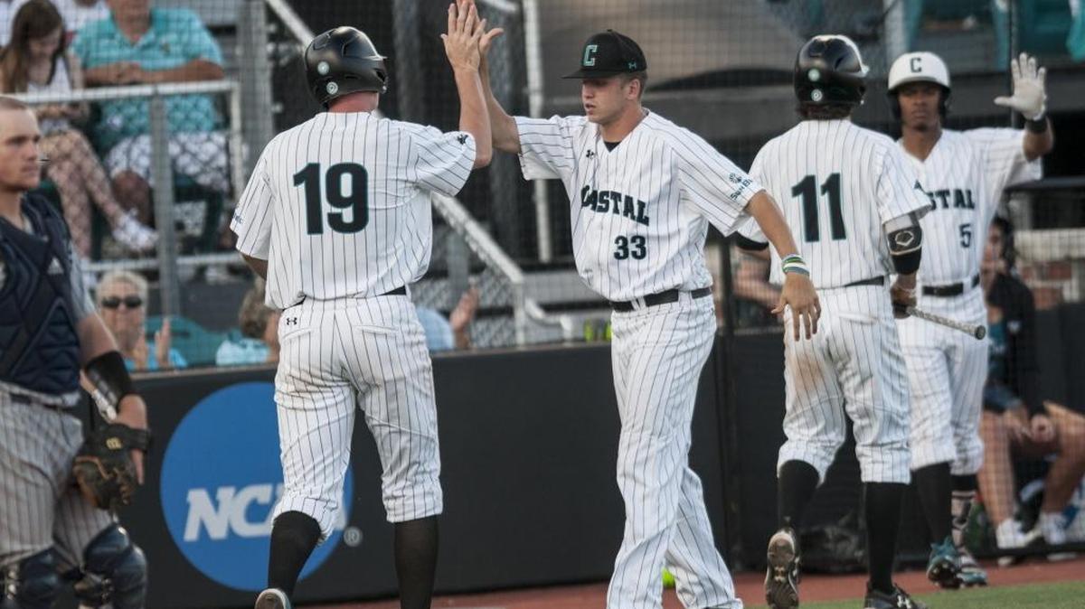 Coastal Carolina’s Kevin Woodall Jr. (19) and Jordan Gore (11) get congratulations from their teammates after scoring against Georgia Southern on Friday night.