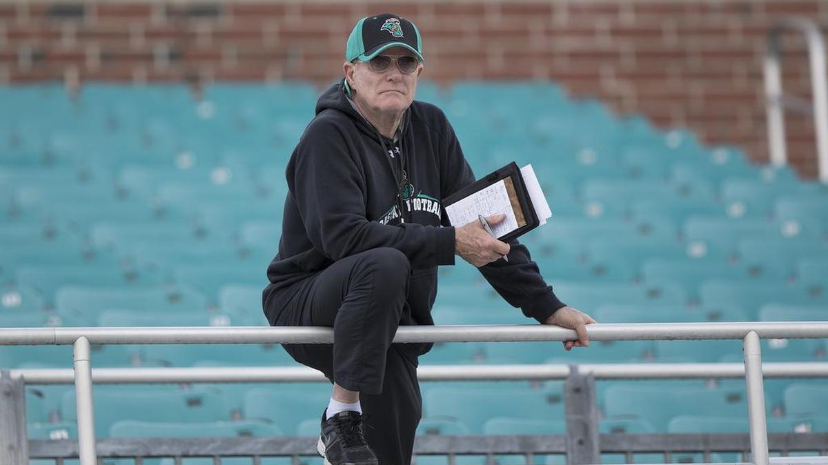 Coastal Carolina football coach Joe Moglia looks on from the stands at Brooks Stadium in Conway during a spring practice in February.