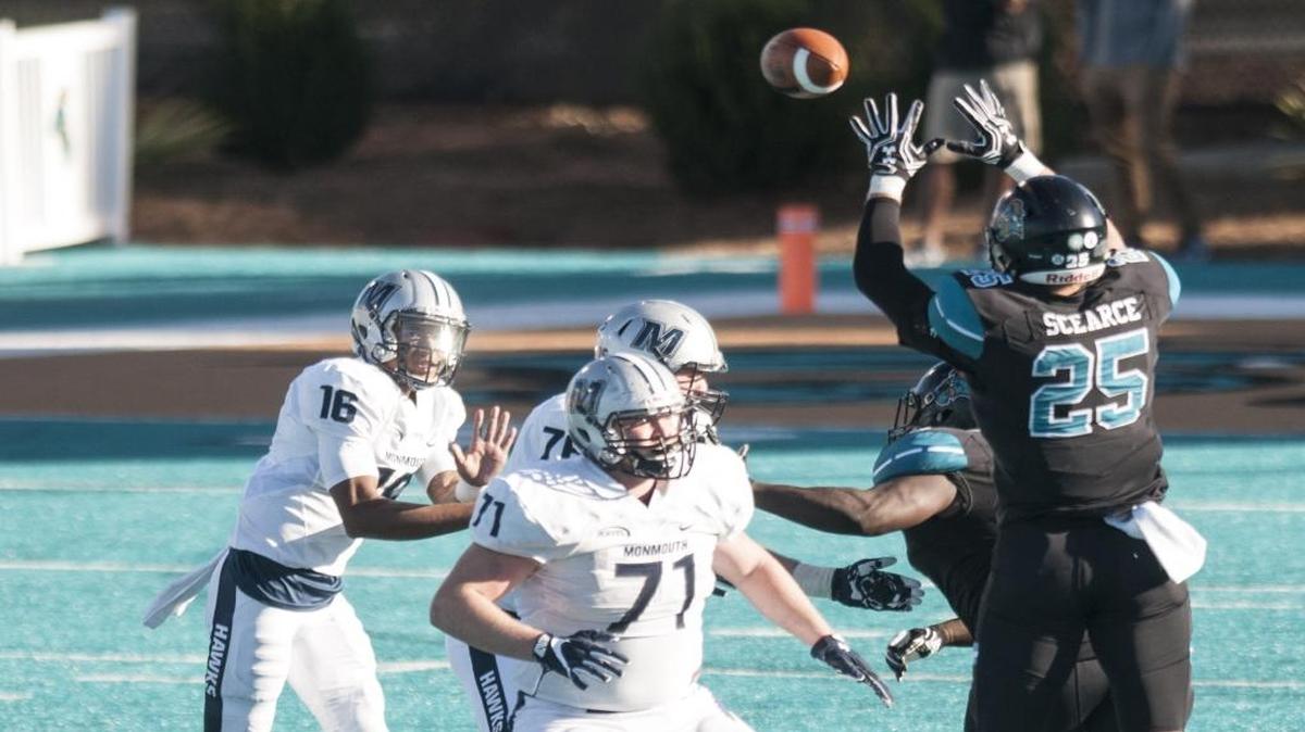 Coastal Carolina senior Alex Scearce knocks down a pass from Monmouth’s Kenji Bahar earlier this season.