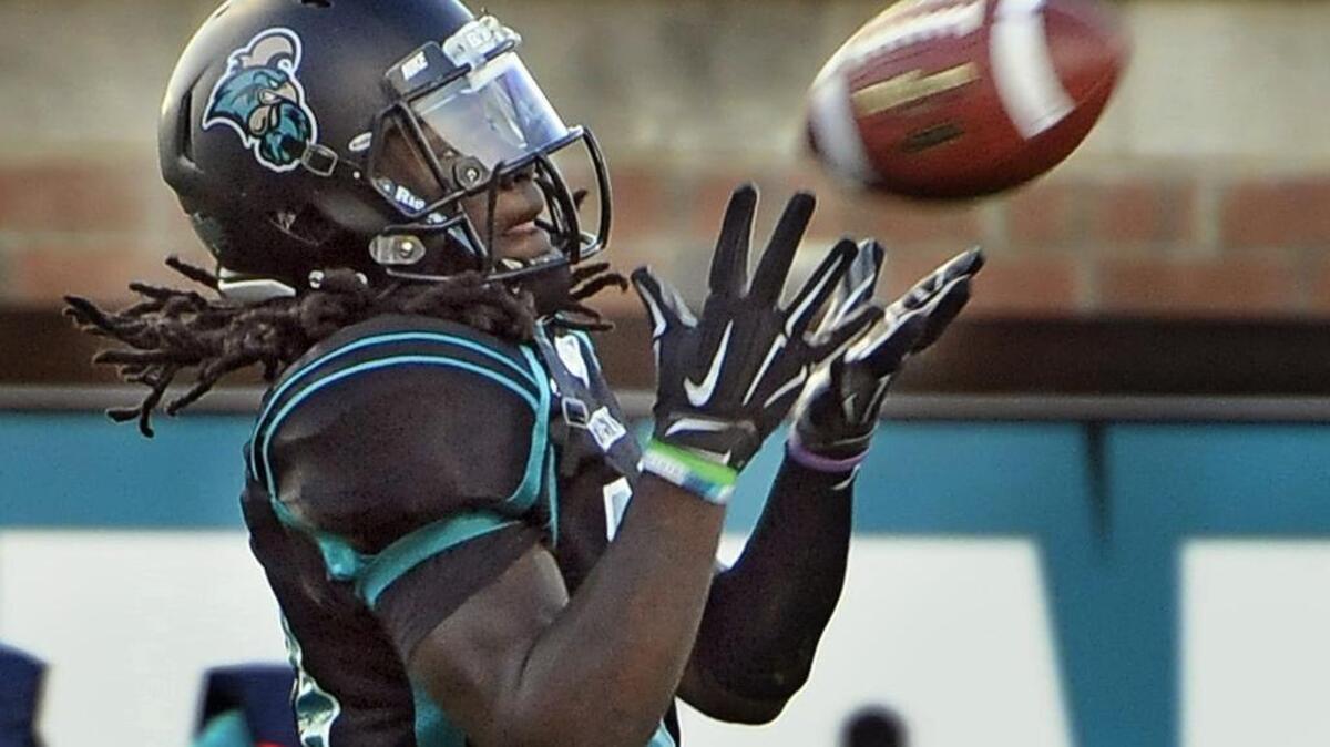 
Coastal Carolina wide receiver John Israel catches an Alex Ross pass against Monmouth last season at Brooks Stadium
