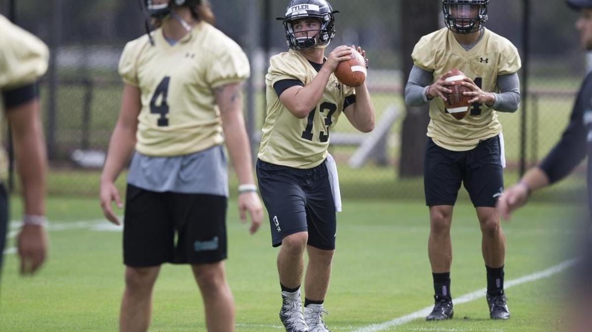 Senior quarterback Tyler Keane (13) goes through drills during a Coastal Carolina football practice.