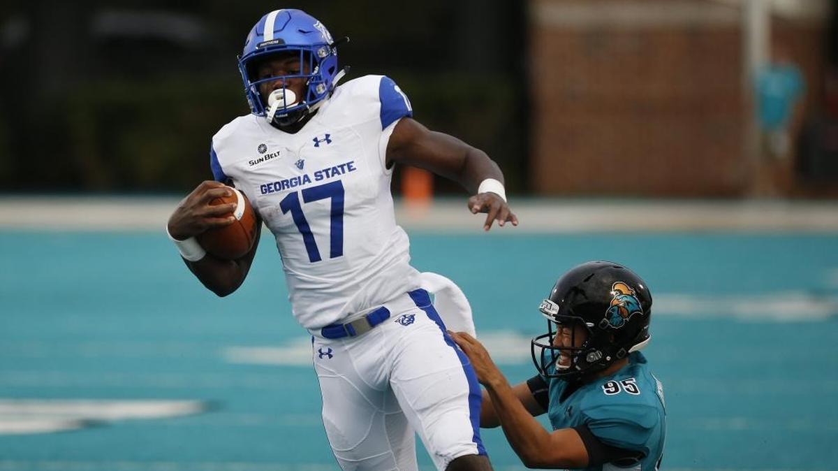 Georgia State kick returner Glenn Smith (17) gets by Coastal Carolina kicker Masamitsu Ishibashi (95) as Smith runs for a touchdown on the opening play of the game Saturday at Brooks Stadium in Conway.