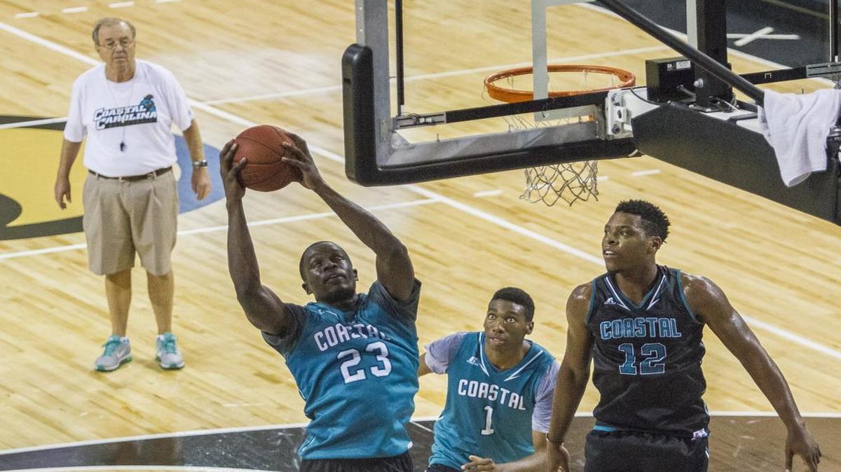 
Coastal Carolina coach Cliff Ellis (left) watches as his team performs drills on the first day of practice.
