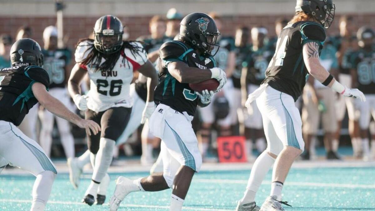 Coastal Carolina’s De’Angelo Henderson looks for running room against Gardner-Webb.