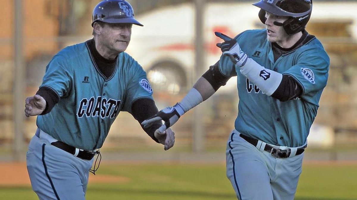 
Coastal Carolina head coach Gary Gilmore congratulates former catcher Casey Schroeder after his two-run home run during a game with Old Dominion.

