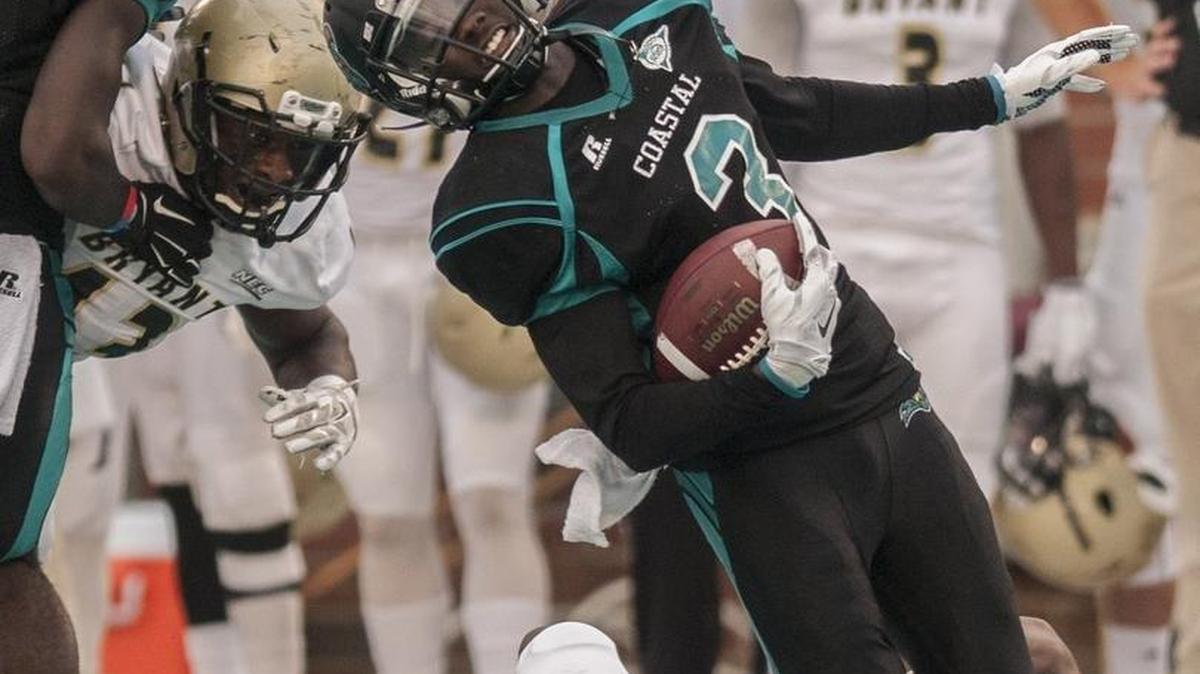
Tyrell Blanks is tackled by Bryant's Aaron Gilmer. 
