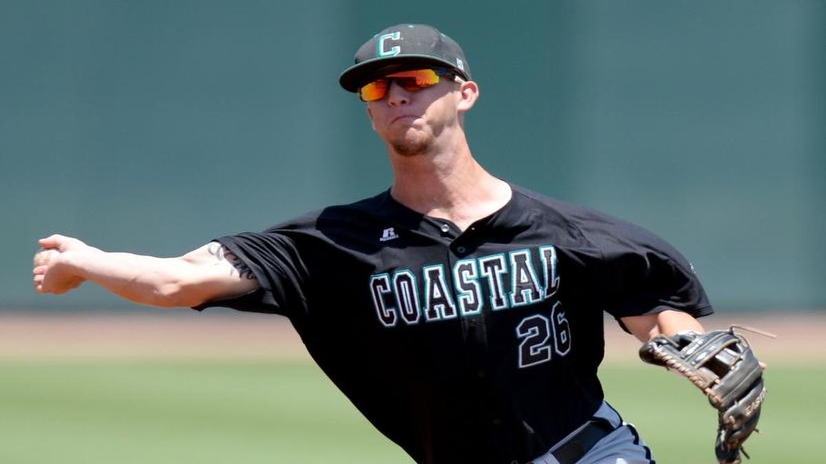 
Coastal Carolina’s Seth Lancaster throws out a Texas A&M runner at first base Sunday.
