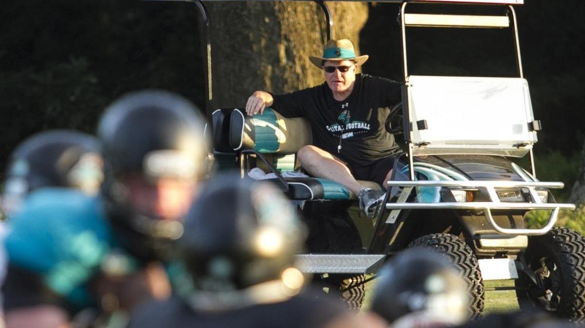 Coastal Carolina coach Joe Moglia watches practice from his golf cart earlier this season.