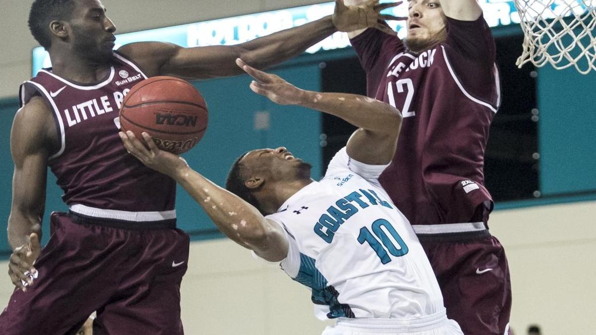 Coastal Carolina’s Shivaughn Wiggins (10) goes up for a shot between Little Rock defenders Monday night. The Chants won 66-63.
