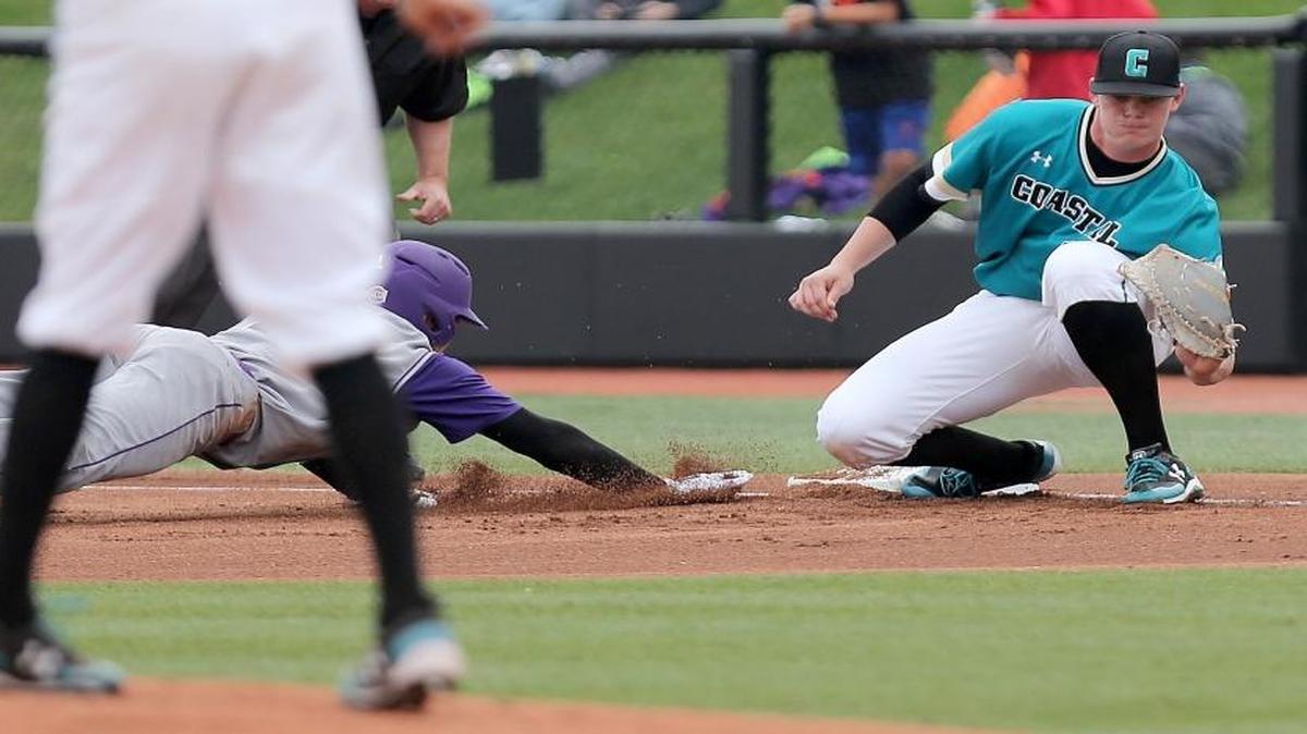 Coastal Carolina’s Kevin Woodall Jr. (right) hit his Sun Belt-leading 10th home run Saturday.