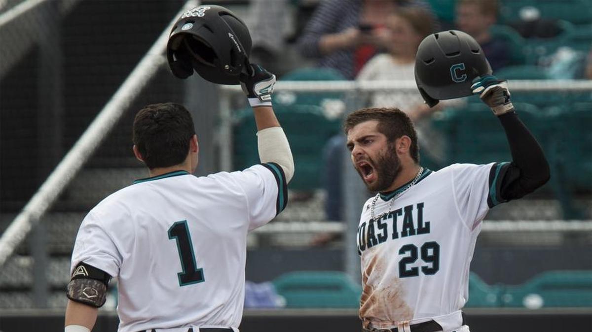 Coastal Carolina players Anthony Marks (29) and Michael Paez (1) celebrate after Paez’s two run homer against Gardner-Webb during a game a few weeks ago.
