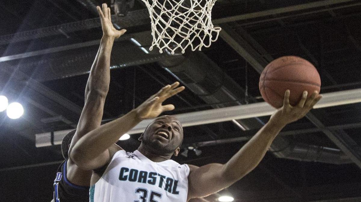 Coastal Carolina’s Marcus Freeman works around a Presbyterian defender during a recent game. The senior forward will miss the next few weeks after injuring his foot.