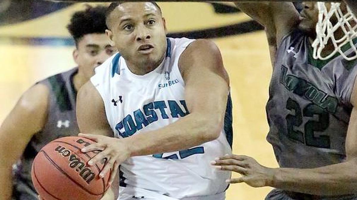 Coastal Carolina University’s Elijah Wilson (22) shoots in Monday’s College Basketball Invitational game with Loyola University. Coastal won 72 to 63.