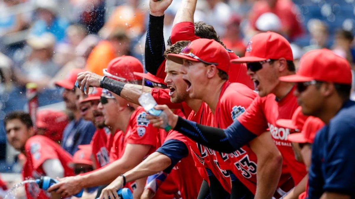 Arizona players celebrate in the dugout after Kyle Lewis scored a run against Oklahoma State on a double by Louis Boyd during the second inning Saturday.
