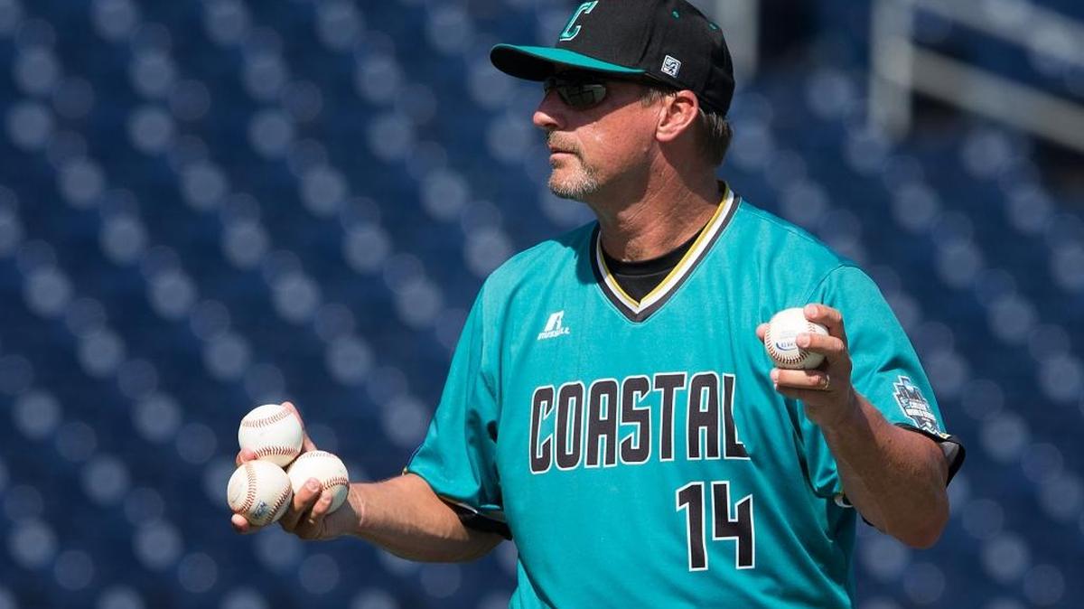 Coastal Carolina coach Gary Gilmore prepares to pitch during practice Friday.