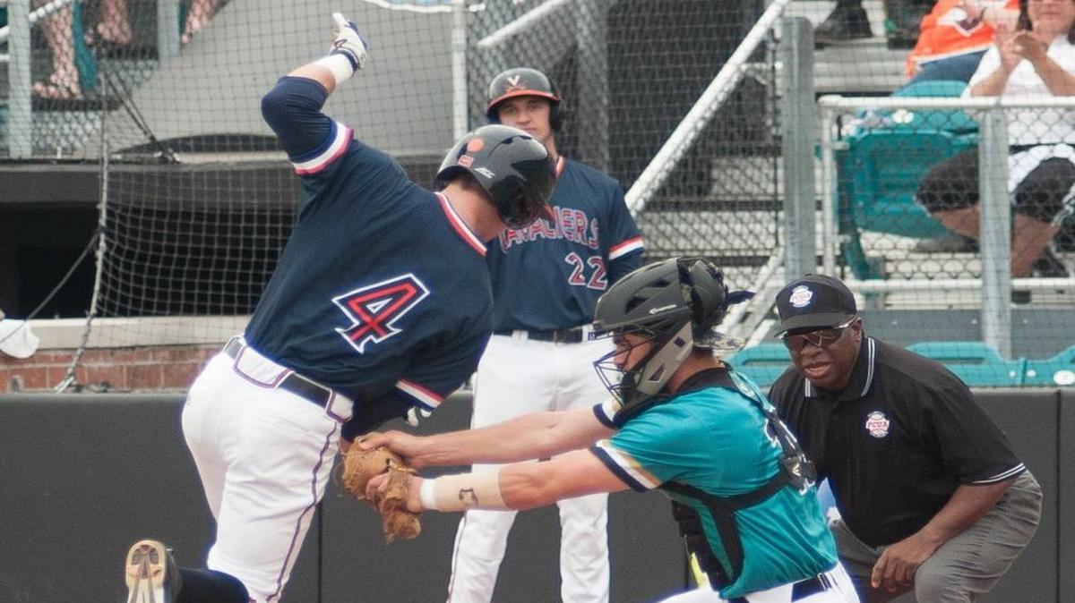 Coastal Carolina’s Matt Beaird tags out Virginia’s Ernie Clement at home plate Sunday.