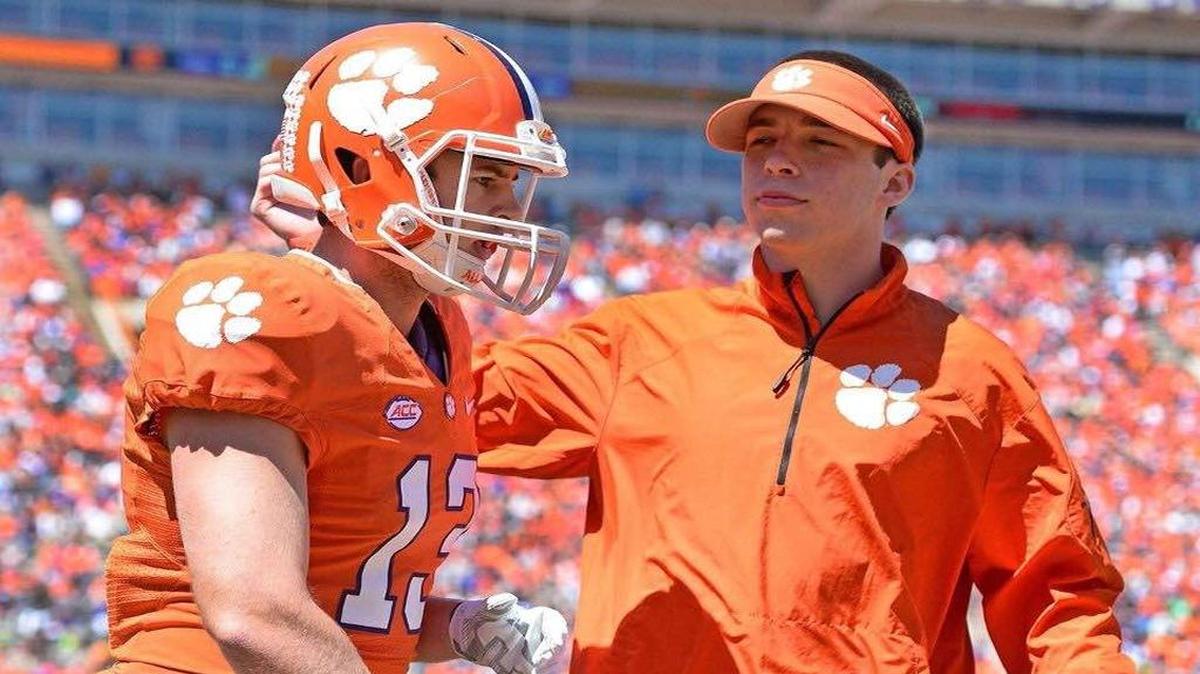 Clemson student assistant to the offense Sawyer Jordan taps lifelong friend and former Socastee standout Hunter Renfrow on the helmet ahead of a game earlier this season.