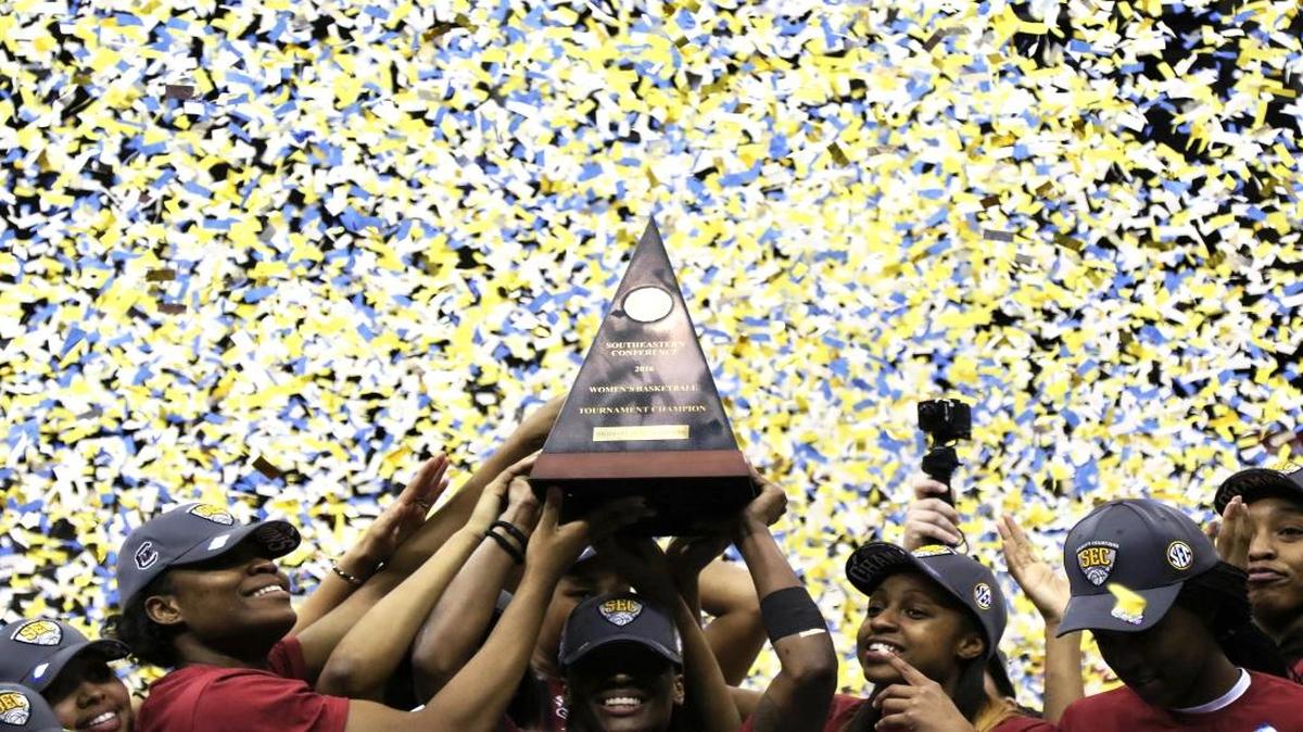 The South Carolina Gamecocks hold women's SEC basketball tournament champion trophy this past March.