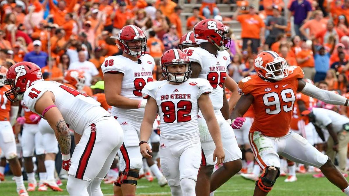 North Carolina State kicker Kyle Bambard (92) walks off of the field after missing a field goal late as regulation time expired against Clemson on Saturday.