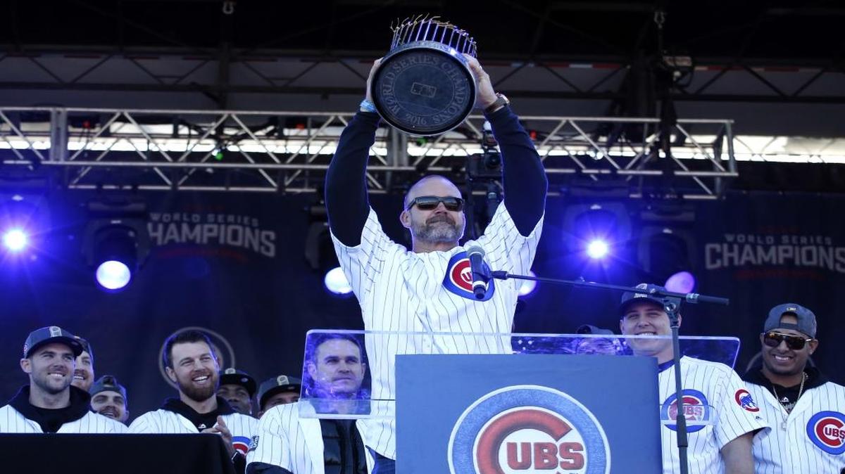 The Cubs’ David Ross holds the Commissioner’s Trophy during a celebration honoring the World Series champions at Grant Park in Chicago on Nov. 4.