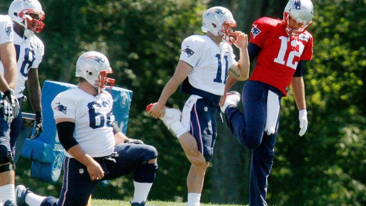 
New England Patriots quarterback Tom Brady (right) warms up next to wide receiver Julian Edelman (11) at a practice on Saturday. A federal judge overturned Brady's four-game suspension last Thursday. The Patriots host the Pittsburgh Steelers to open the NFL season Thursday night.
