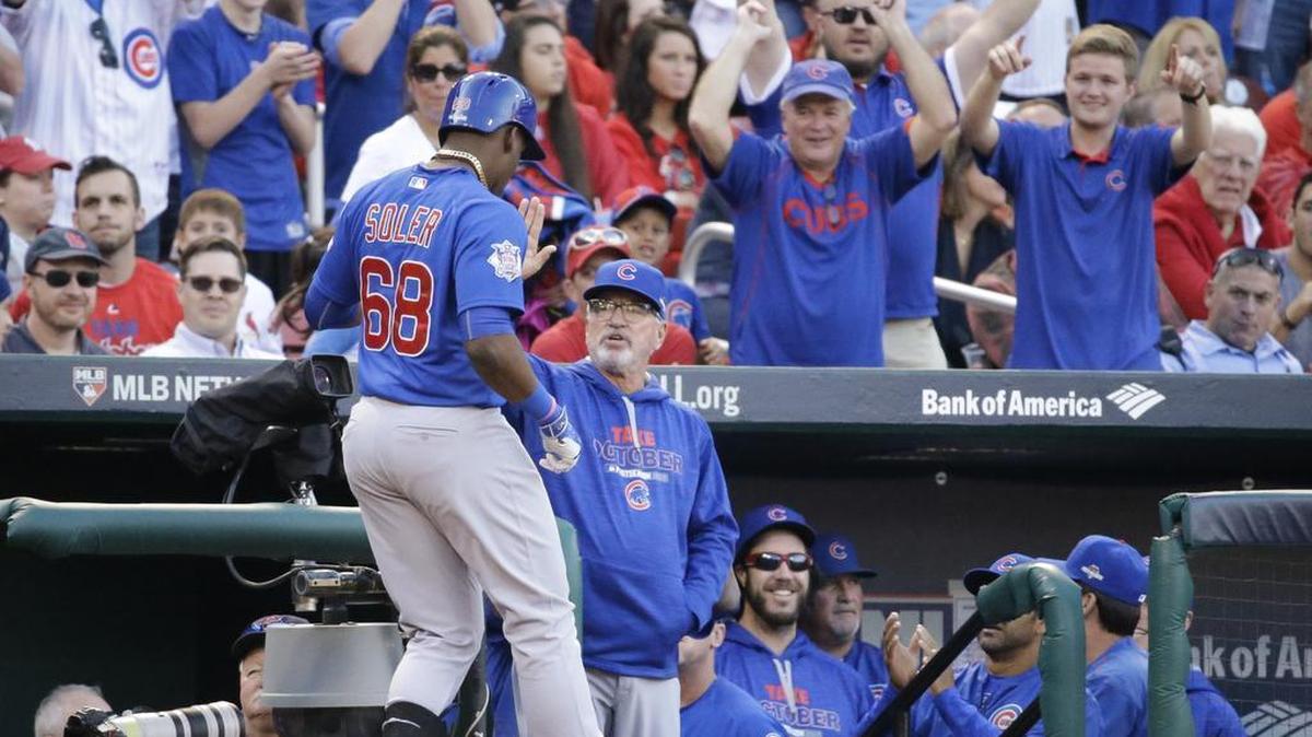 
Chicago Cubs' Jorge Soler celebrates with manager Joe Maddon after Soler hit a two-run home run during the second inning of Game 2 in baseball's National League Division Series against the St. Louis Cardinals.
