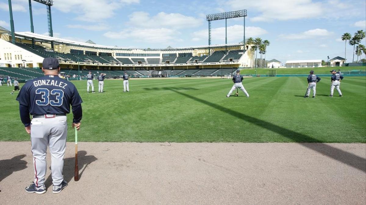 Atlanta Braves manager Fredi Gonzalez (33) watches batting practice from the outfield during a spring training workout Sunday.
