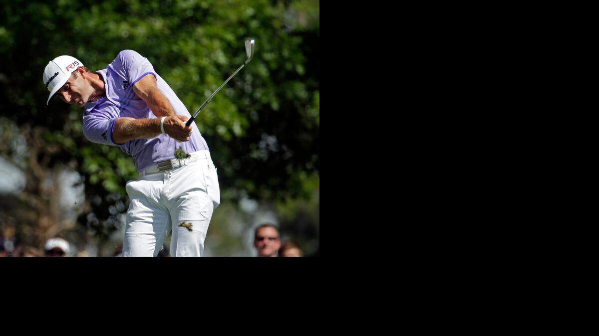 
Dustin Johnson tees off on the fourth hole during the third round of the Masters on Saturday in Augusta, Ga. 
