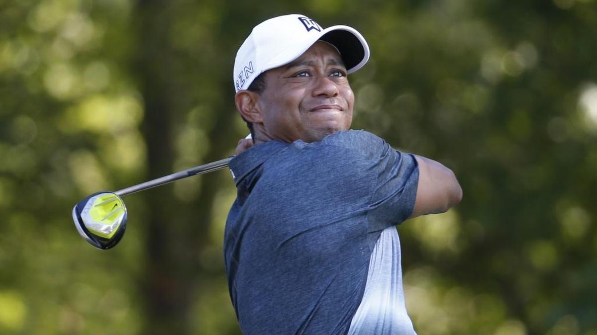 In this July 31, 2015, file photo, Tiger Woods watches his tee shot on the 13th hole during the second round of the Quicken Loans National golf tournament, in Gainesville, Va. Tiger Woods says he hopes to play next month in the PGA's Safeway Open in Napa, California, his first competitive golf since August 2015.